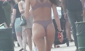 Amazing fit girl with bubble ass takes a walk to the beach