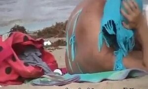 two mature in thong on the beach